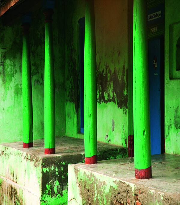 Exterior of a home in Nagapattinam with fine green pillars. Tamil Nadu. South India.